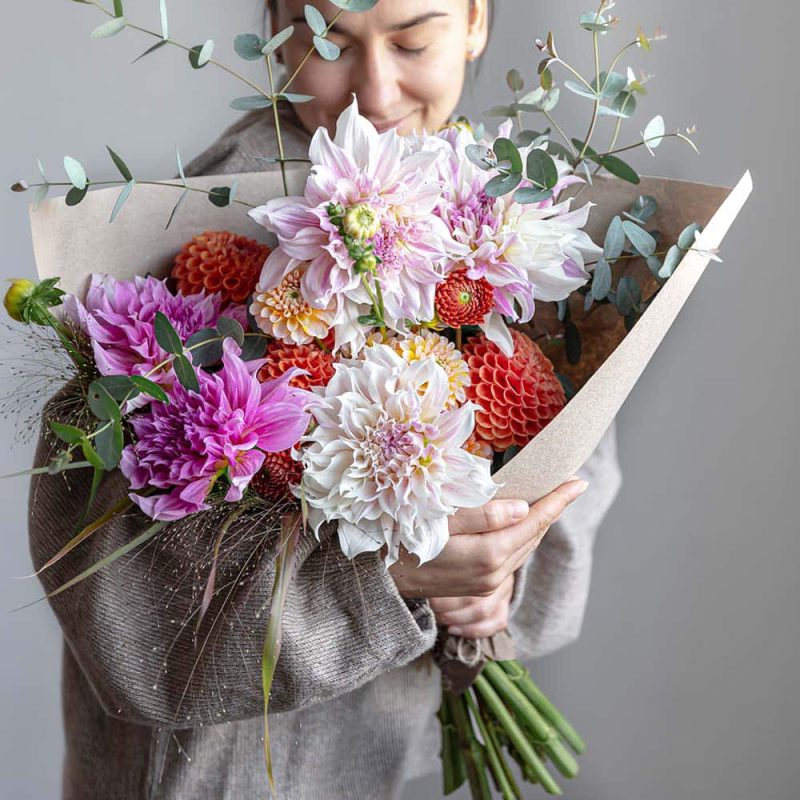 young-woman-with-a-large-festive-bouquet-of-chrysa-WR7TUBE.jpg